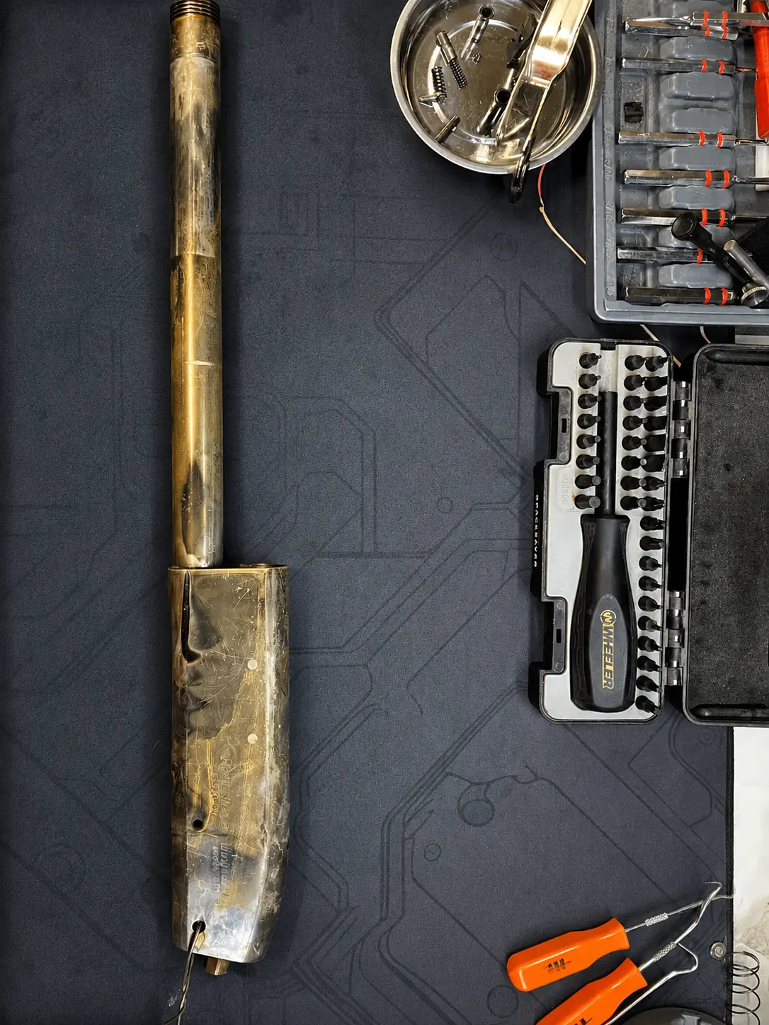 Stripped firearm receiver and barrel prepared for the next surface-preparation stage